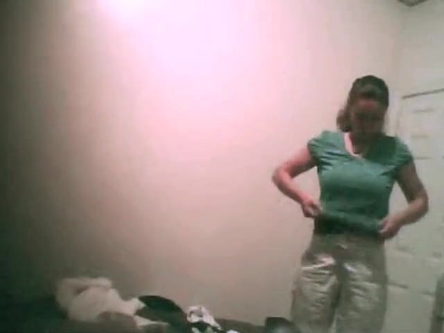 College girl changing top in bedroom