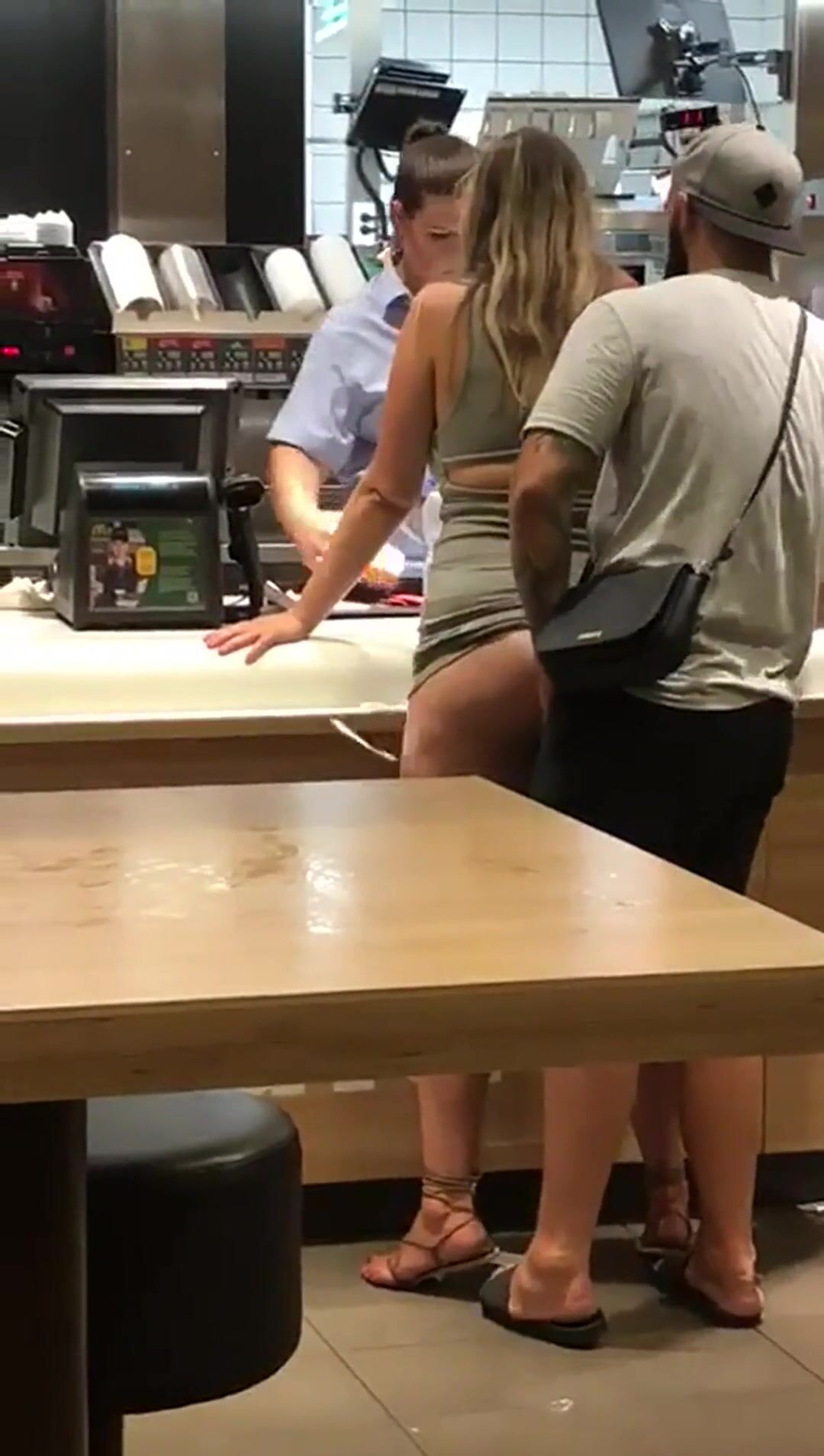 Guy slides into his girl at the McDonald’s counter