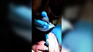 a tattoo artist sucking on her clients