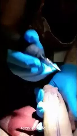 a tattoo artist sucking on her clients