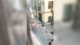 100s of naked women running & walking down the street